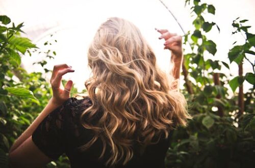 Blonde-haired Woman Standing Between Green Plants